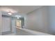 Bright hallway with neutral walls, lighting fixtures, and view into the bathroom at 321 Cape Sable Dr, Orlando, FL 32825