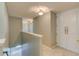 Hallway with gray walls, tile floors, white door, and stairwell at 321 Cape Sable Dr, Orlando, FL 32825