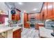 Kitchen with wood cabinetry, granite countertops, mosaic backsplash, and stainless steel appliances at 321 Cape Sable Dr, Orlando, FL 32825