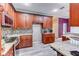 Kitchen with granite countertops, mosaic backsplash, wood cabinets, and stainless steel appliances at 321 Cape Sable Dr, Orlando, FL 32825
