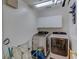 Laundry room with front load washer and dryer, white storage cabinets and tiled floor at 321 Cape Sable Dr, Orlando, FL 32825