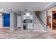 Open-concept living room featuring gray walls, blue accent wall, decorative wall, white trim, and gray wood-look tile flooring at 321 Cape Sable Dr, Orlando, FL 32825