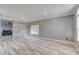 Bright living room with wood-look flooring, light gray walls, and decorative wood accent wall at 321 Cape Sable Dr, Orlando, FL 32825