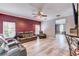 Living room featuring modern ceiling fan, gray and maroon accent wall at 321 Cape Sable Dr, Orlando, FL 32825