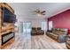 Open concept living room features modern fireplace, sliding glass door and ceiling fan at 321 Cape Sable Dr, Orlando, FL 32825