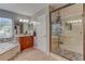 Well-lit bathroom with a soaking tub, granite counters, double sinks, and glass shower at 321 Cape Sable Dr, Orlando, FL 32825