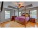 Spacious main bedroom featuring a four-poster bed, wood floors, and ample natural light at 321 Cape Sable Dr, Orlando, FL 32825