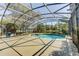 Lovely screened-in pool has an adjacent spa and a beautiful lake view at 321 Cape Sable Dr, Orlando, FL 32825