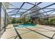Backyard oasis with a screened-in pool, spa, and mature landscaping with beautiful lake views at 321 Cape Sable Dr, Orlando, FL 32825