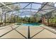 Screened pool with adjacent spa and lake views provides the perfect outdoor escape at 321 Cape Sable Dr, Orlando, FL 32825