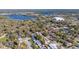 Aerial view of neighborhood with mature trees, homes, and a lake visible in the background at 321 Ferdinand Dr, Longwood, FL 32750