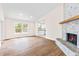 Inviting living room with a stone fireplace, hardwood floors and recessed lighting at 321 Ferdinand Dr, Longwood, FL 32750