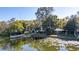 Scenic view of a peaceful pond with lily pads, surrounded by lush greenery and a gazebo at 321 Ferdinand Dr, Longwood, FL 32750