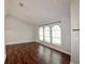 Living room features three arched windows bringing in lots of natural light and wood-look flooring at 3548 Picciola Cutoff Rd, Fruitland Park, FL 34731