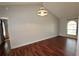 Bright living room with beautiful wood floors and vaulted ceiling with decorative light fixture at 3548 Picciola Cutoff Rd, Fruitland Park, FL 34731