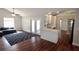 Bright living room featuring hardwood floors, white walls, and a cozy dark grey sofa at 3548 Picciola Cutoff Rd, Fruitland Park, FL 34731