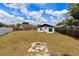 Spacious backyard with wooden fence, perfect for outdoor entertaining and complete with a unique fire pit feature at 4458 Goldenrain Ct, Orlando, FL 32808