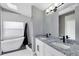 Bright bathroom featuring double sink vanity with granite countertop, updated fixtures, and a shower/tub combination at 4458 Goldenrain Ct, Orlando, FL 32808