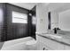 Updated bathroom featuring black subway tile and a modern sink and vanity at 4458 Goldenrain Ct, Orlando, FL 32808