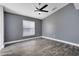 Bedroom features new wood-look flooring, updated ceiling fan, fresh paint, and a window allowing natural light at 4458 Goldenrain Ct, Orlando, FL 32808