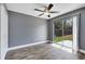 Bright bedroom with ceiling fan and sliding glass door to backyard at 4458 Goldenrain Ct, Orlando, FL 32808