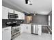 Kitchen with stainless steel appliances and white cabinetry at 4458 Goldenrain Ct, Orlando, FL 32808