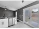Modern kitchen with stainless dishwasher and door to backyard at 4458 Goldenrain Ct, Orlando, FL 32808