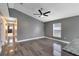 Spacious living room with wood-look tile flooring and ample natural light at 4458 Goldenrain Ct, Orlando, FL 32808