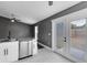 Spacious living room featuring gray wood-look floors, a window, and granite kitchen counters and appliances at 4458 Goldenrain Ct, Orlando, FL 32808