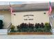 Windmeadows community clubhouse entrance with planted foliage and American flags at 482 Windmeadows St # 482, Altamonte Springs, FL 32701