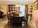 Cozy dining area with a round wooden table and a china cabinet near the window at 482 Windmeadows St # 482, Altamonte Springs, FL 32701