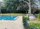 Community pool area features lush landscaping, shaded trees, and comfortable lounge chairs at 482 Windmeadows St # 482, Altamonte Springs, FL 32701