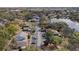 Aerial view of residential community next to a lake surrounded by mature trees and foliage at 4825 Lighthouse Cir # 4825, Orlando, FL 32808