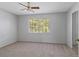 Bedroom featuring neutral carpet, ceiling fan and a window at 4825 Lighthouse Cir # 4825, Orlando, FL 32808