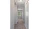 Hallway with multiple closets leading to a bedroom with natural light at 4825 Lighthouse Cir # 4825, Orlando, FL 32808