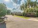 Gated community entrance with lush landscaping and mature trees in Phillips Cove at 5215 Phillips Oaks Ln, Orlando, FL 32812