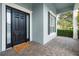 Inviting entryway with a black front door, brick tile and lovely welcome mat at 5215 Phillips Oaks Ln, Orlando, FL 32812