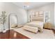 Well-lit main bedroom with a neutral color palette, wood floors, and a plush rug at 5215 Phillips Oaks Ln, Orlando, FL 32812