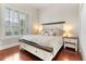 Beautiful main bedroom with a king bed, shuttered windows and bedside tables with lamps at 5215 Phillips Oaks Ln, Orlando, FL 32812