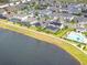 An aerial view of a lakeside community with home pools and a community pool at 5647 Barletta Dr, St Cloud, FL 34771