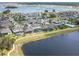 An aerial view of a lakeside neighborhood, showcasing homes with pools and scenic water views at 5647 Barletta Dr, St Cloud, FL 34771