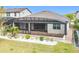 Aerial view of backyard with screened patio, landscaping and view of neighborhood at 5647 Barletta Dr, St Cloud, FL 34771