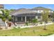 An aerial view of a backyard featuring a covered, screened-in patio and manicured landscaping at 5647 Barletta Dr, St Cloud, FL 34771