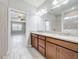 Bathroom showcasing double granite vanity and lighting with an open concept to the primary bedroom at 5647 Barletta Dr, St Cloud, FL 34771