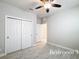 A bright bedroom with a closet and ceiling fan. Neutral walls and flooring would fit any style at 5647 Barletta Dr, St Cloud, FL 34771