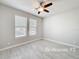 This bedroom features tile flooring, natural light from the windows, and a ceiling fan at 5647 Barletta Dr, St Cloud, FL 34771