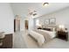 Spacious bedroom features a ceiling fan, ensuite bath, and neutral decor at 5647 Barletta Dr, St Cloud, FL 34771