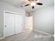 This bedroom features tile flooring, a large closet and a neutral color palette at 5647 Barletta Dr, St Cloud, FL 34771