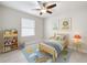 This bedroom has a blue rug, a toddler bed, and a bookshelf for a kid to be happy in their room at 5647 Barletta Dr, St Cloud, FL 34771