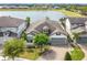 Beautiful lake view home with brick driveway, well-manicured lawn, and attached two-car garage at 5647 Barletta Dr, St Cloud, FL 34771
